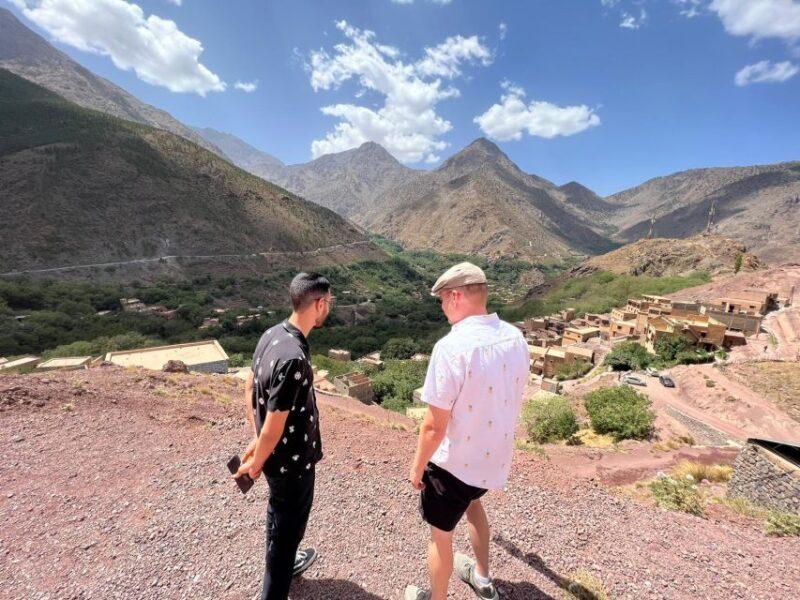 Two travelers overlooking a Berber village in the High Atlas Mountains