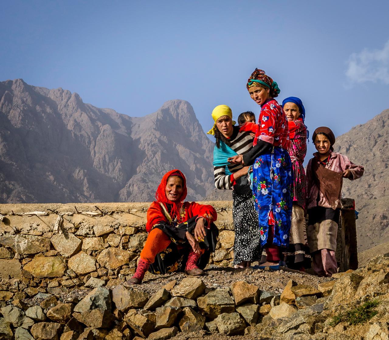 A Berber family in traditional dress on a mountainside in the High Atlas